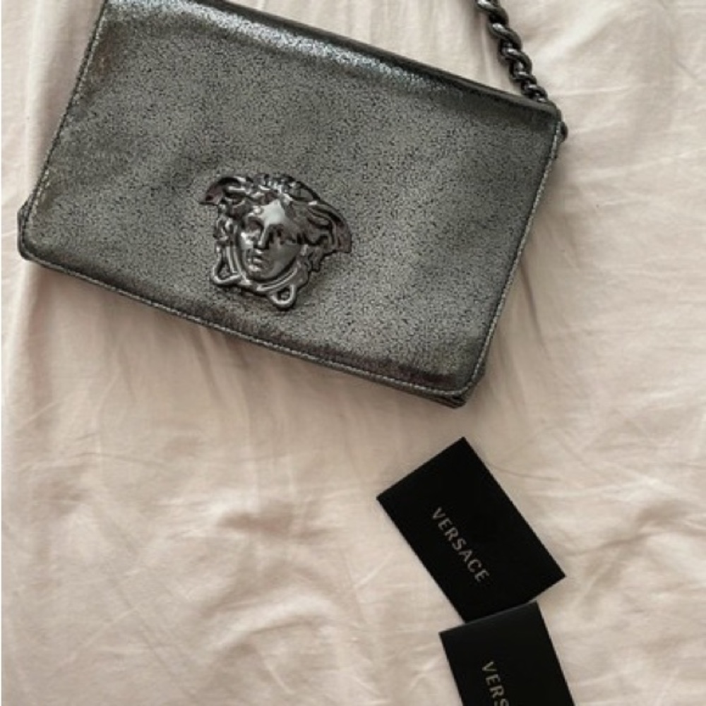 Versace leather silver handbag looks brand new.